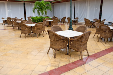 Brown wooden chairs an tables on patio