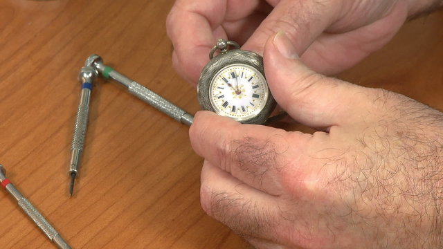 Watchmaker examine pocket watch
