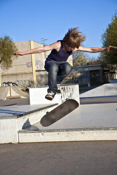 boy with scateboard is going airborne