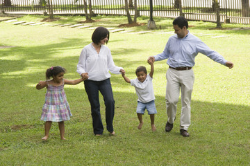 Mom and dad walking with their children