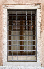 Fototapeta na wymiar Old Venice Window with metal bars