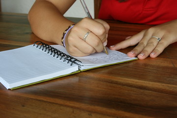 Female writing in journal