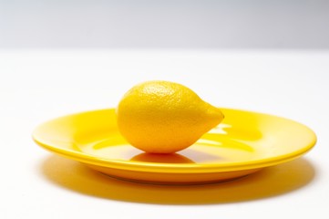 lemon on yellow plate