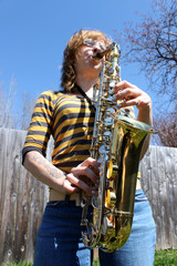 Woman plays saxophone outdoors