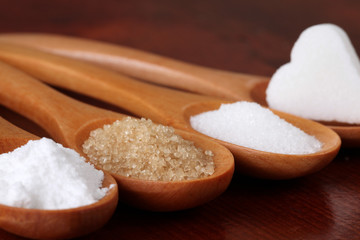 Sugar in wooden spoons
