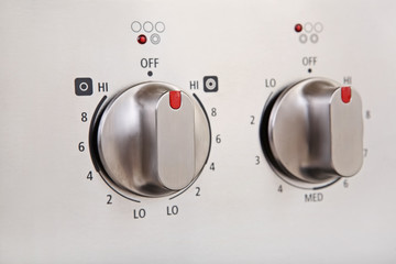 Knobs on a modern stainless steel stove