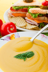 Yellow soup and sandwich