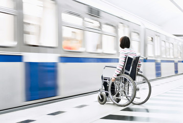 Woman in the wheelchair at the underground station