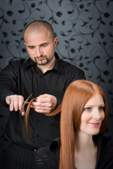 Professional hairdresser with fashion model at luxury salon