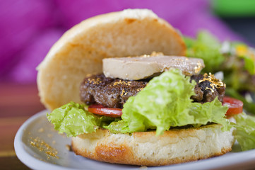 Beef burger in a bun with fois gras