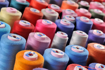 Colorful reels of threads background TAILOR related images.