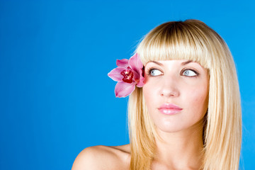Young pretty girl with flower in hair portrait