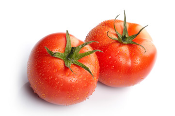 Close-up photo of two tomatoes with water drops..