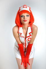 Young sexy nurse with red hair and shirt dress
