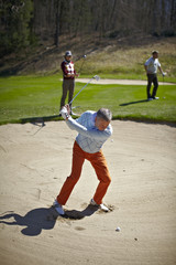 Man at the bunker on a golf course - 22220954