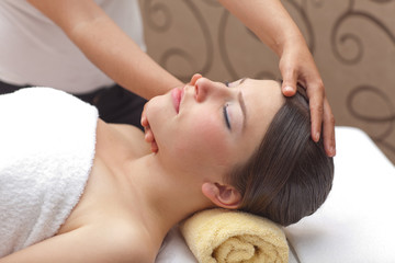 Young woman receiving head massage