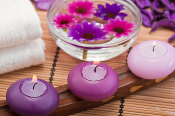 Obraz na płótnie Canvas purple candles and flowers in spa setting (2)
