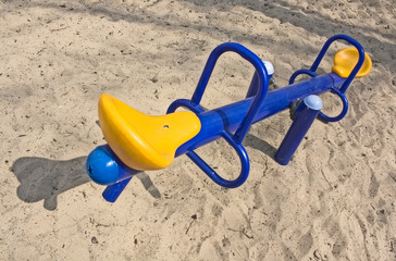 An empty seesaw in a playground