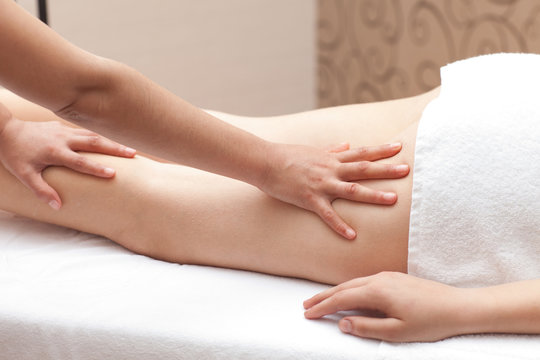 Woman enjoying a leg massage in a spa setting