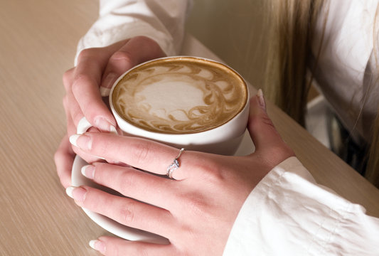 hands of  girl keeps cup  coffee