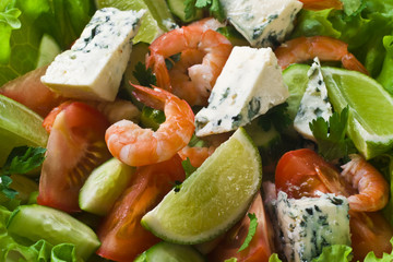 Vegetable salad with shrimps and cheese
