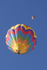 two balloons flying in the blue sky