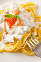 fettuccine with salmon, cream sauce and fork