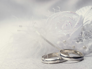 Two silver weddings rings and floral  decoration