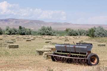 Fototapeta premium Haystacks and baler