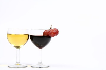 Two glasses of wine and red grapes and white space for text