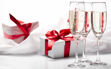 Gift decorated with bow, glass wine