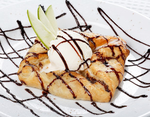 apple cake and ice-cream on a white plate.