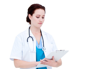 Serious caucasian female doctor making notes in a patient's fold