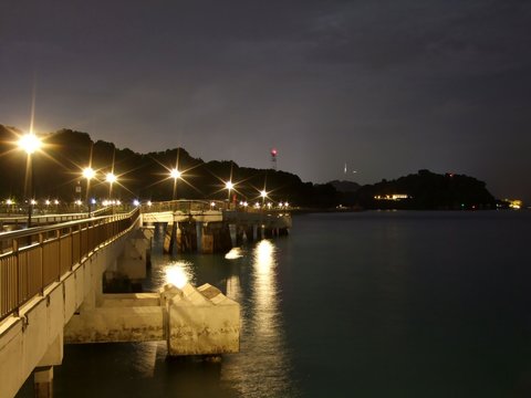 View of lighted Labrador Park Jetty with dark sea and sky