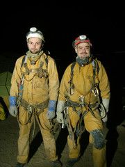 Caver passing the narrowness of the cave.