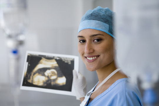 Female doctor holding sonogram