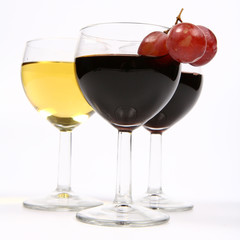 Red and white wine with three red grapes on white