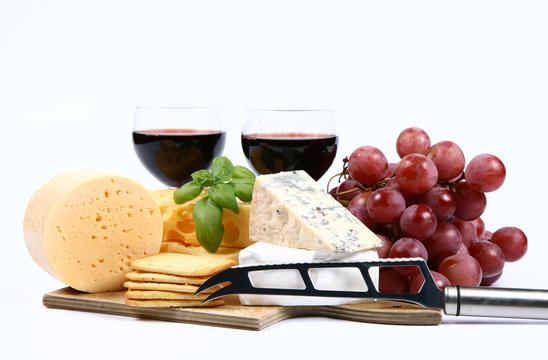 Various types of cheese with wine,grapes,crackers,knife