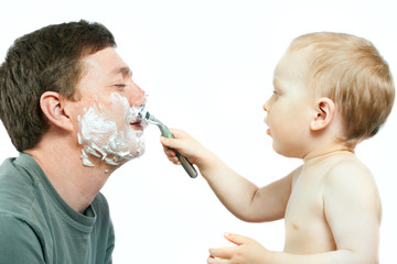 boy shaving father