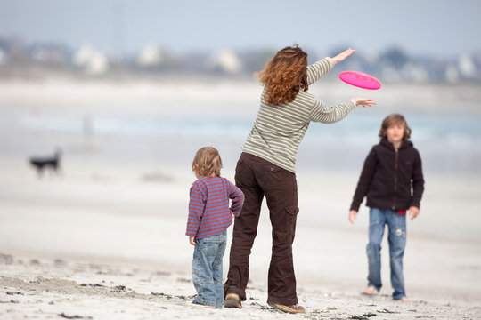 famille jeu plage détente amuser frisbee enfant maman jouer mer