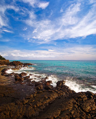 Tropical stones beach under blue sky. Thailand