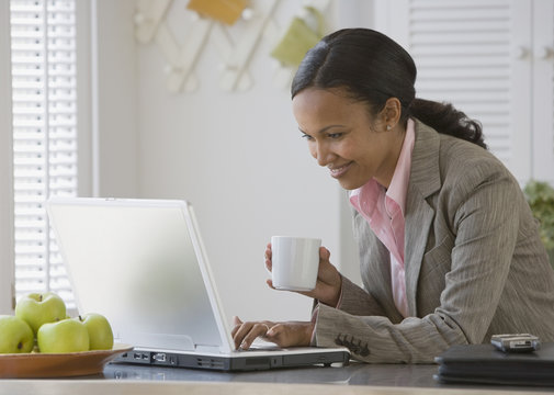 African American businesswoman looking at laptop