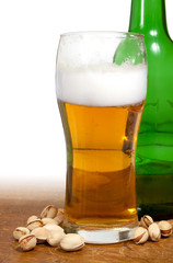 beer in glass, bottle and pistachios
