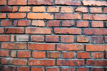 Fototapeta premium old weathered stained red brick wall background.