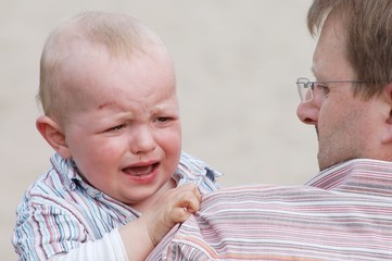 crying baby with father