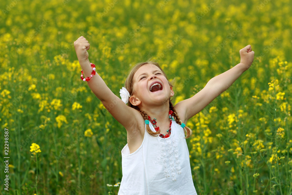 Wall mural Pretty young girl screaming with delight in a rapeseed field