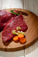 beef steak with ingredients over cutting board