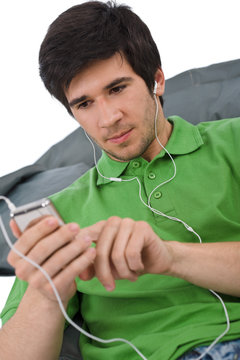 Young Man With Ear Buds Listening To Music