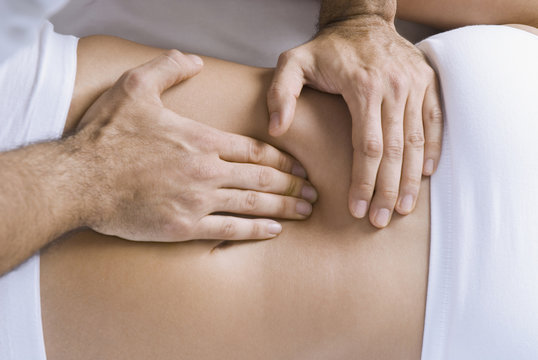 Chiropractor adjusting womanÕs spine