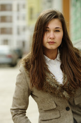 Portrait of young woman in jacket with fur collar